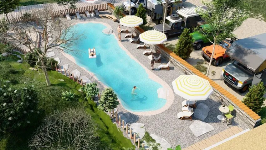 Aerial view of custom beach pool with natural sand and luxury amenities