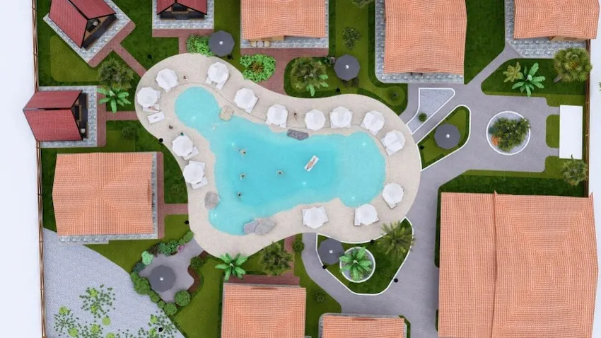 Top-down view of tropical pool surrounded by private beach villas